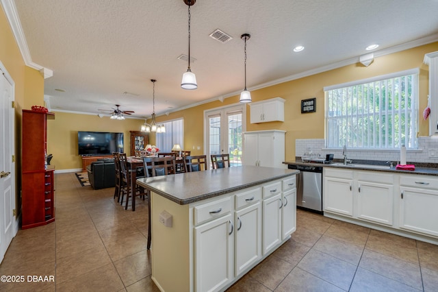 10 Cantilever Ct, Ormond Beach, FL 32174 - kitchen featuring stainless steel dishwasher, dark countertops, ornamental molding, backsplash, and a center island