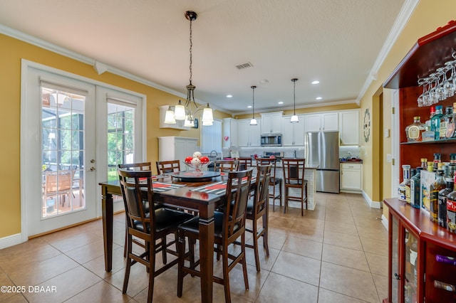 10 Cantilever Ct, Ormond Beach, FL 32174 - dining room with ornamental molding, light tile patterned floors, french doors, recessed lighting, and baseboards