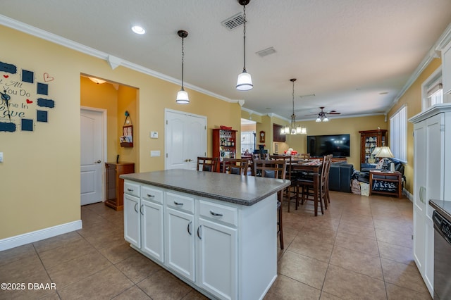 10 Cantilever Ct, Ormond Beach, FL 32174 - kitchen featuring dark countertops, light tile patterned floors, ornamental molding, a ceiling fan, and white cabinets