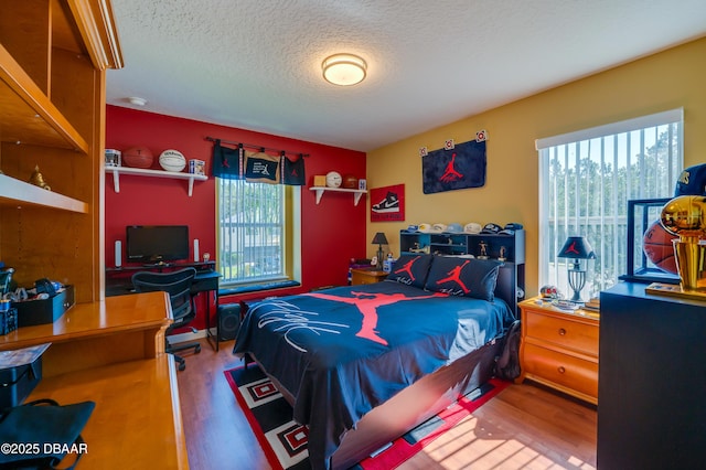 10 Cantilever Ct, Ormond Beach, FL 32174 - bedroom featuring multiple windows, wood finished floors, a textured ceiling, and an office area