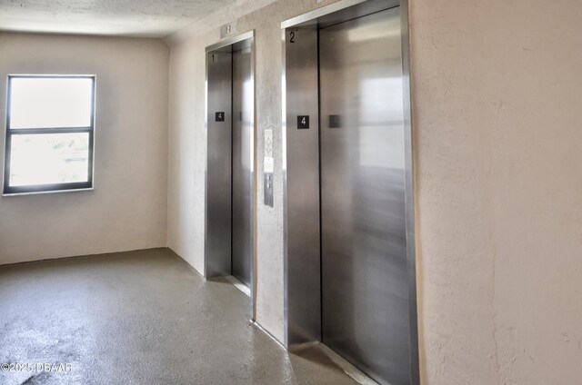 4435 S Atlantic Ave Unit 416, Ponce Inlet, FL 32127 - hall featuring elevator and finished concrete floors
