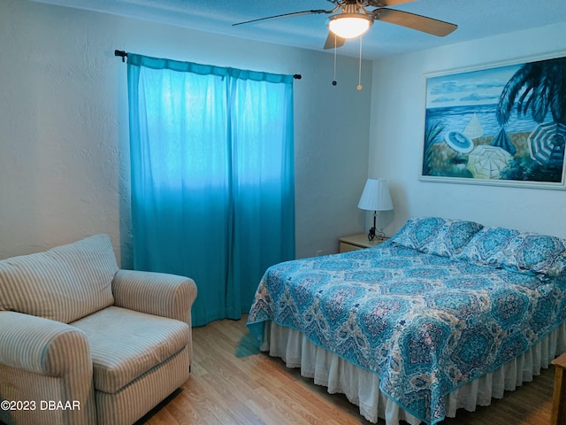 bedroom with hardwood / wood-style flooring and ceiling fan