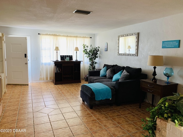 tiled living room with a textured ceiling