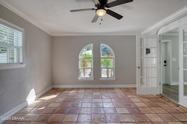 empty room featuring french doors, ceiling fan, and crown molding