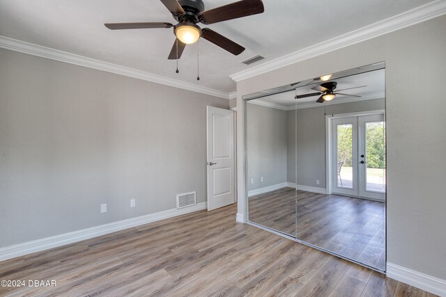 spare room with ornamental molding, french doors, light hardwood / wood-style floors, and ceiling fan