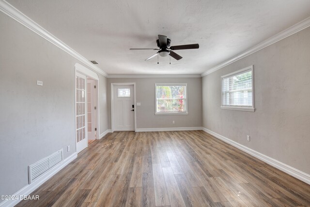 interior space with ceiling fan, light hardwood / wood-style flooring, and ornamental molding