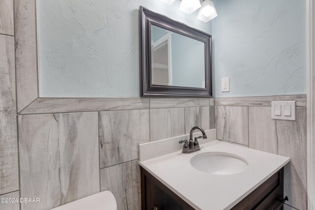 bathroom with toilet and vanity