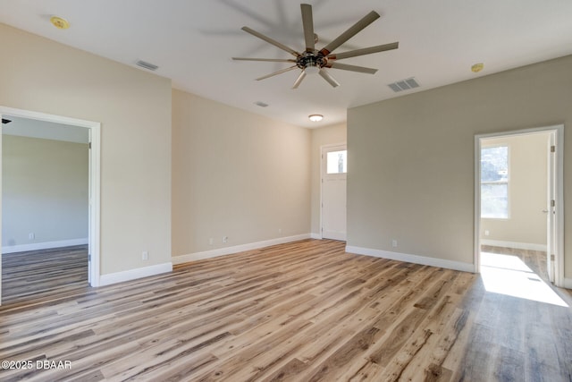 empty room featuring ceiling fan and light hardwood / wood-style flooring