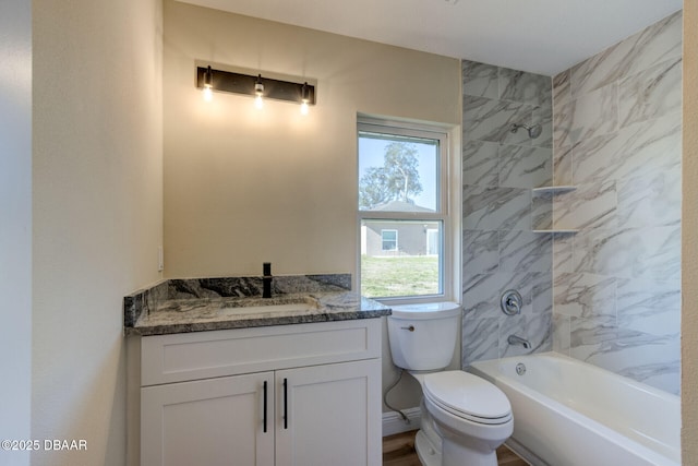 full bathroom featuring vanity, toilet, and tiled shower / bath combo