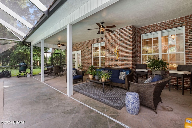 view of patio featuring a lanai, ceiling fan, and an outdoor hangout area