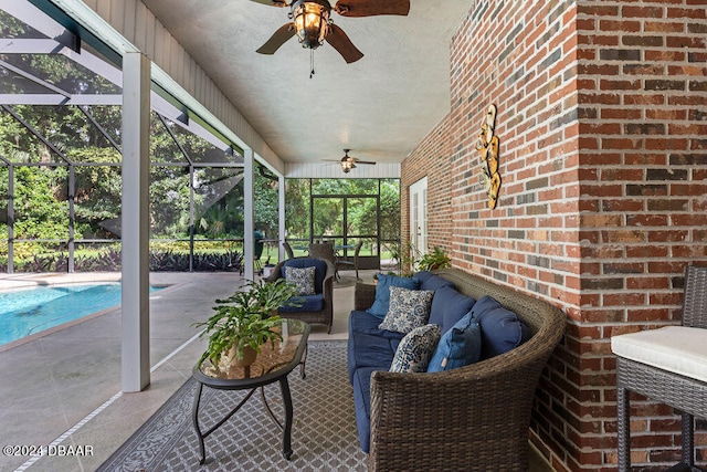 view of patio / terrace featuring an outdoor living space, ceiling fan, and a lanai