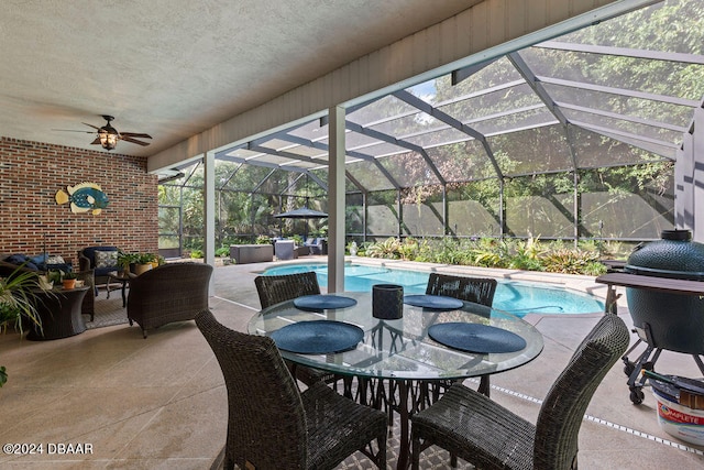 view of patio / terrace featuring grilling area, a fenced in pool, glass enclosure, and ceiling fan