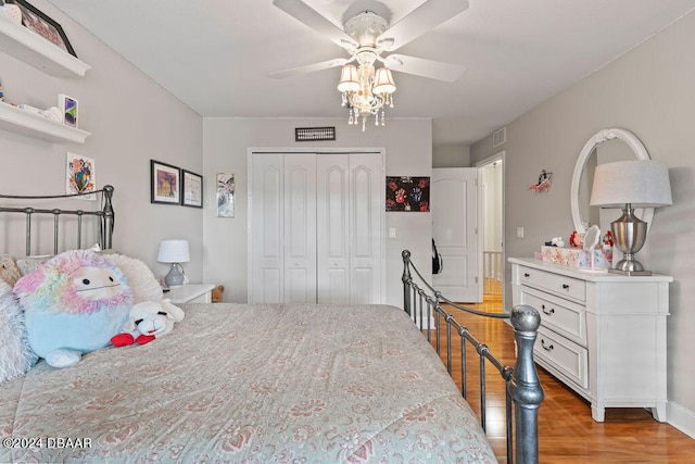 bedroom featuring ceiling fan, a closet, and hardwood / wood-style flooring