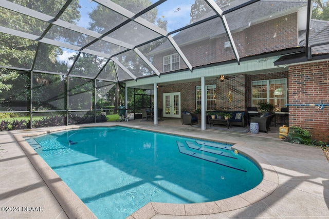 view of pool with glass enclosure, french doors, and a patio