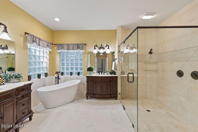 bathroom featuring separate shower and tub and vanity