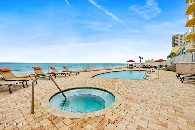 3343 S Atlantic Ave Unit 601, Daytona Beach Shores, FL 32118 - community pool featuring a hot tub, a patio, and a water view