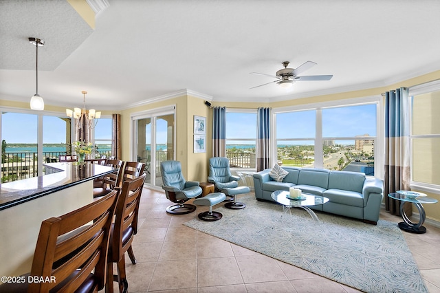 3343 S Atlantic Ave Unit 601, Daytona Beach Shores, FL 32118 - living room featuring a chandelier, ceiling fan, light tile patterned floors, plenty of natural light, and ornamental molding