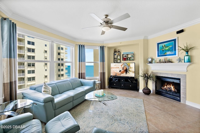 3343 S Atlantic Ave Unit 601, Daytona Beach Shores, FL 32118 - living room with tile patterned floors, crown molding, ceiling fan, and a warm lit fireplace