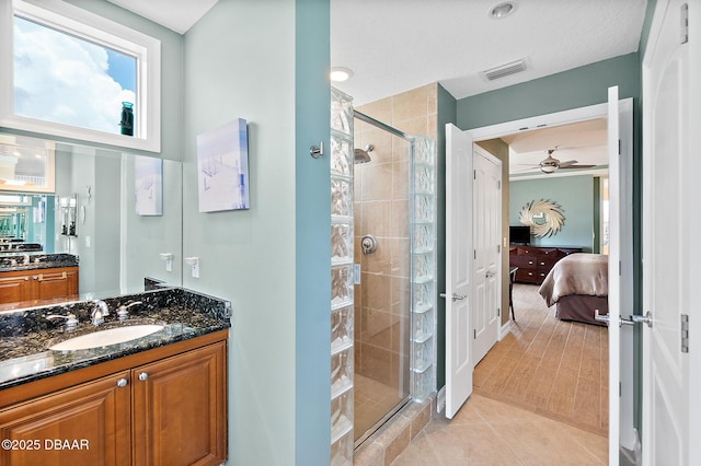 3343 S Atlantic Ave Unit 601, Daytona Beach Shores, FL 32118 - ensuite bathroom featuring a stall shower, vanity, a ceiling fan, and tile patterned floors
