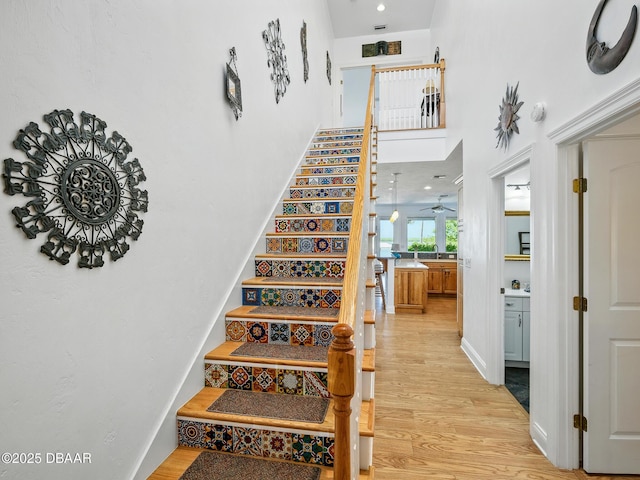 206 S Riverside Dr, Edgewater, FL 32132 - staircase with wood finished floors, a towering ceiling, and a ceiling fan