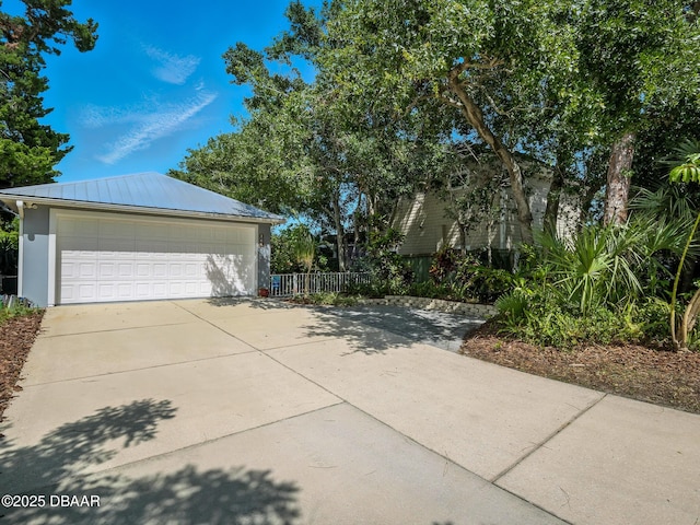 206 S Riverside Dr, Edgewater, FL 32132 - view of side of property with a detached garage and a metal roof