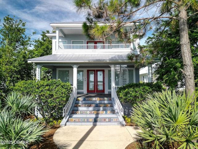 206 S Riverside Dr, Edgewater, FL 32132 - view of front of house featuring french doors, a porch, a balcony, a metal roof, and a standing seam roof