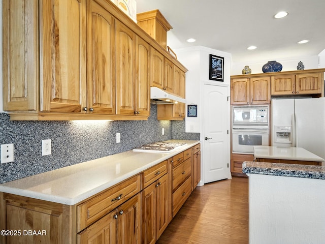 206 S Riverside Dr, Edgewater, FL 32132 - kitchen featuring white appliances, under cabinet range hood, wood finished floors, backsplash, and recessed lighting