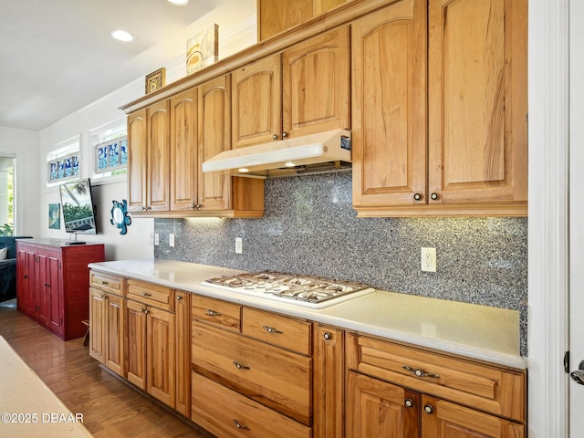 206 S Riverside Dr, Edgewater, FL 32132 - kitchen featuring white gas stovetop, under cabinet range hood, light countertops, tasteful backsplash, and dark wood-style flooring