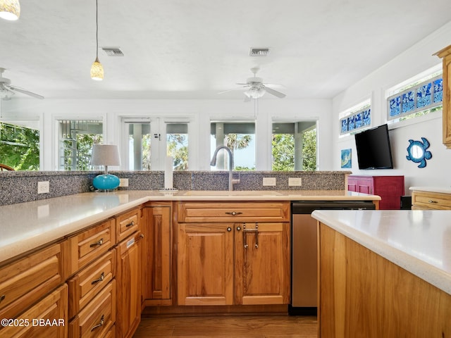 206 S Riverside Dr, Edgewater, FL 32132 - kitchen with ceiling fan, dishwasher, light countertops, and wood finished floors