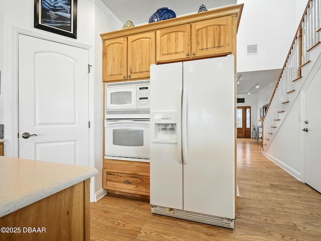 206 S Riverside Dr, Edgewater, FL 32132 - kitchen featuring white appliances, light wood-style flooring, light stone counters, and ornamental molding