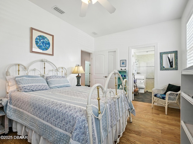 206 S Riverside Dr, Edgewater, FL 32132 - bedroom with wood finished floors, ensuite bath, and a ceiling fan