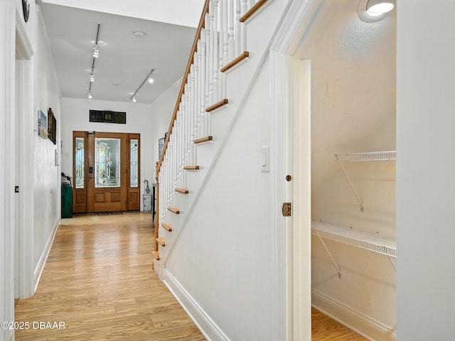 206 S Riverside Dr, Edgewater, FL 32132 - foyer entrance featuring track lighting, light wood finished floors, and stairway