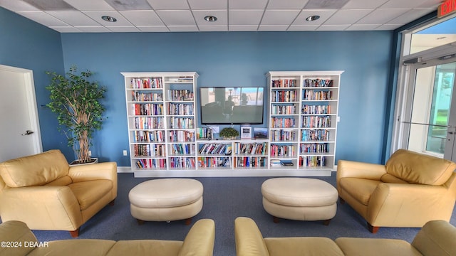 interior space with carpet and a drop ceiling