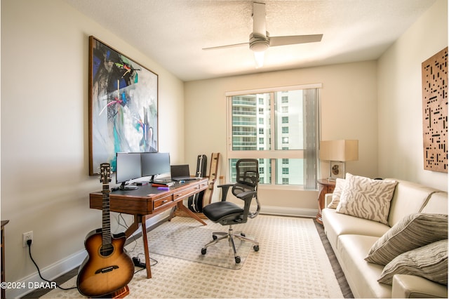 office area with a textured ceiling and ceiling fan