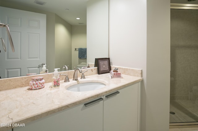 bathroom featuring vanity and a shower with door