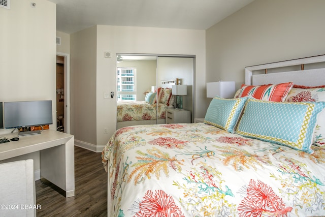 bedroom with dark wood-type flooring and a closet