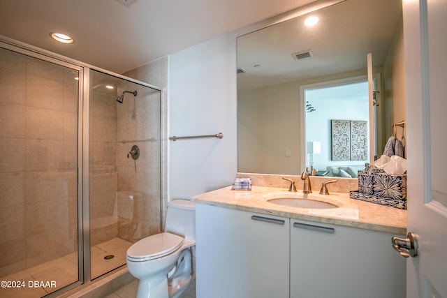 bathroom with vanity, walk in shower, tile patterned floors, and toilet