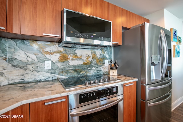 kitchen featuring dark wood-type flooring, appliances with stainless steel finishes, and tasteful backsplash