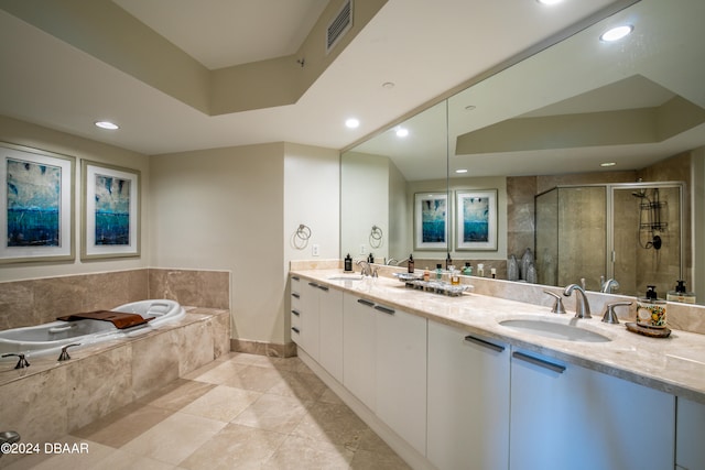 bathroom featuring independent shower and bath, tile patterned flooring, and vanity