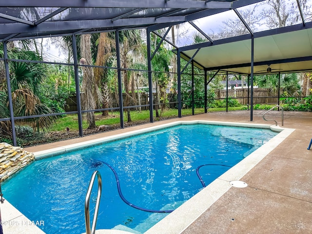 view of swimming pool with a patio area and glass enclosure