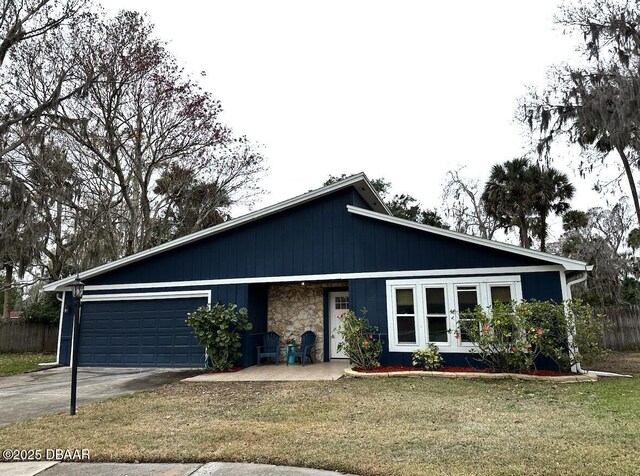 view of front of house featuring a garage and a front lawn