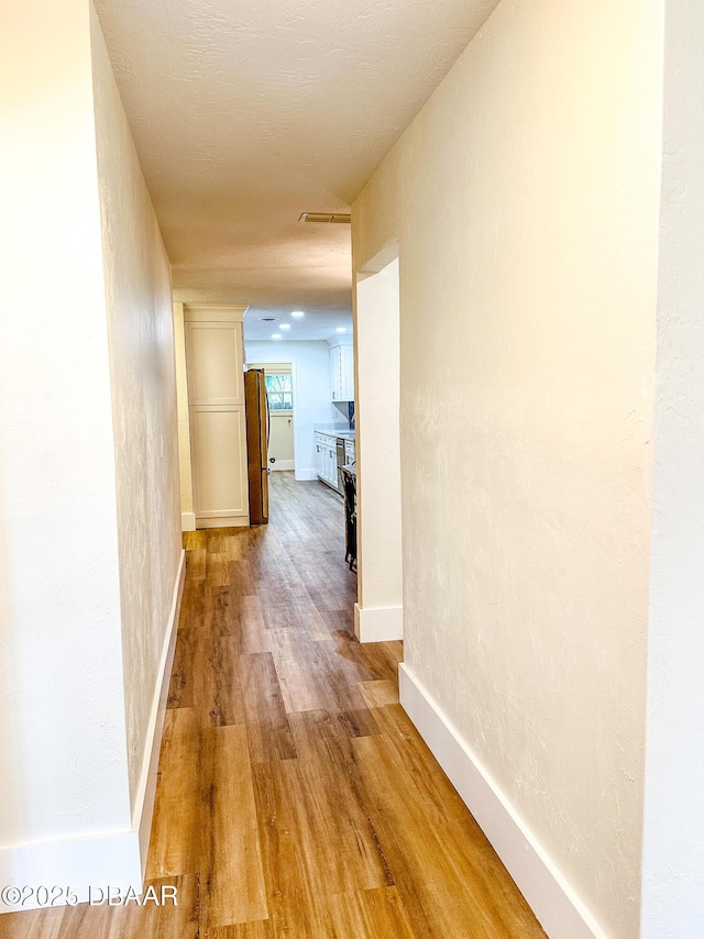 corridor featuring hardwood / wood-style flooring