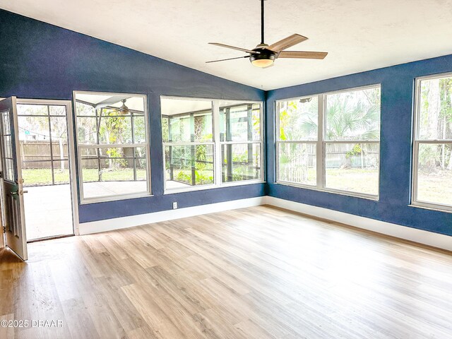 kitchen with sink, white cabinetry, hanging light fixtures, stainless steel dishwasher, and light hardwood / wood-style floors