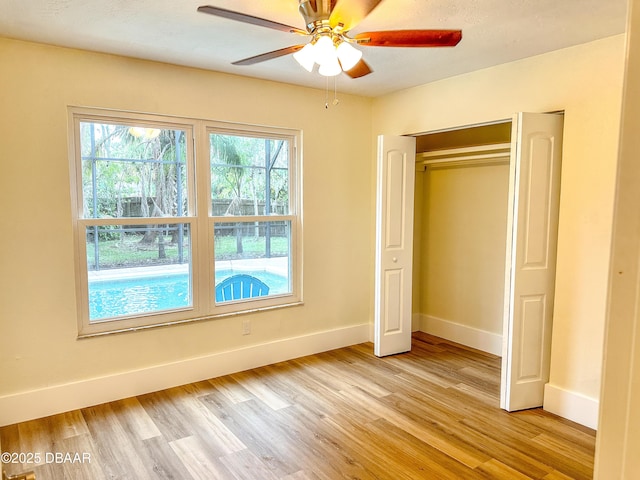 unfurnished bedroom featuring a closet, ceiling fan, and light wood-type flooring