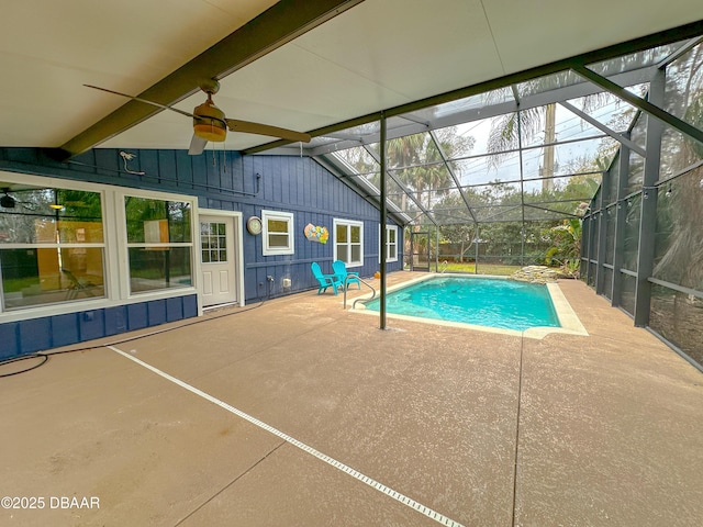 view of pool with ceiling fan, a lanai, and a patio area