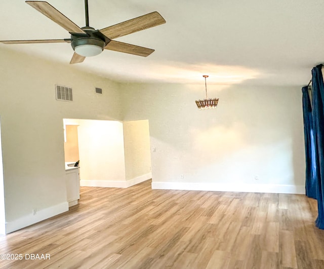 spare room featuring lofted ceiling, light hardwood / wood-style floors, and ceiling fan