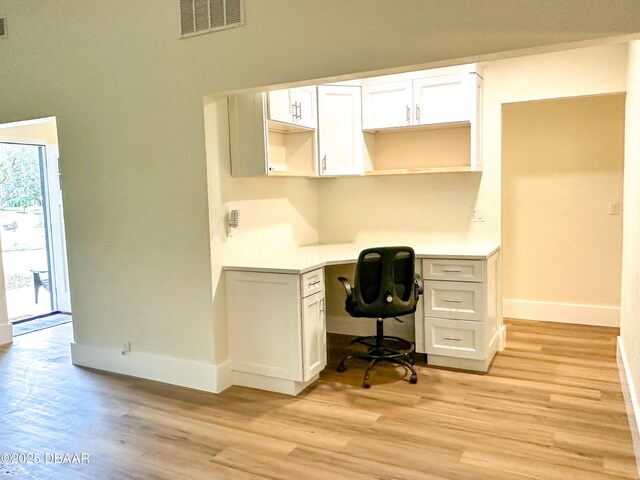 dining area with sink and light wood-type flooring