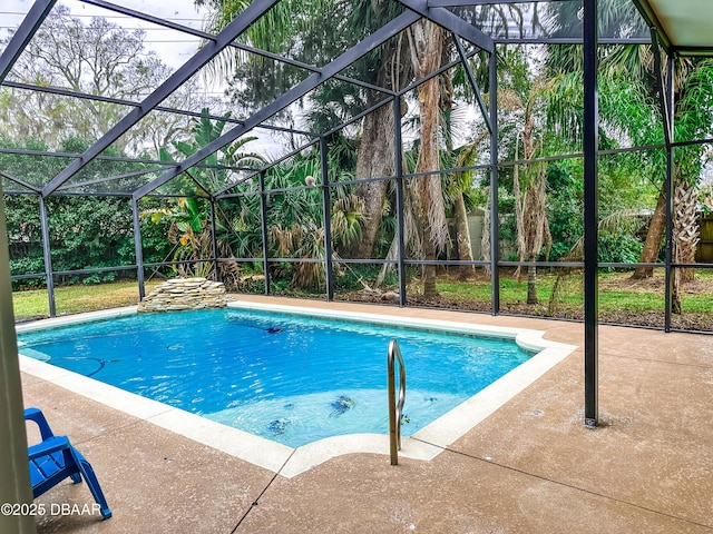 view of swimming pool featuring a patio and glass enclosure