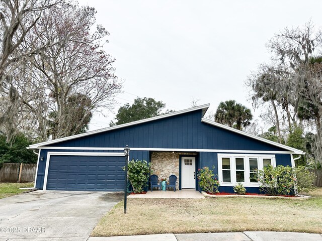 ranch-style home featuring a garage and a front yard