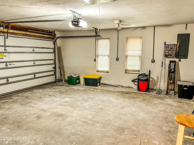 garage with a garage door opener and electric panel